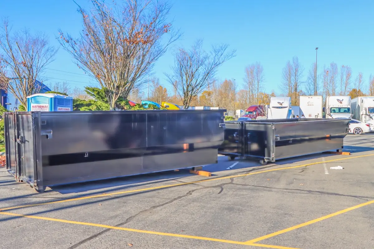 Professional dumpster rental service with roll-off container on residential driveway in Accokeek
